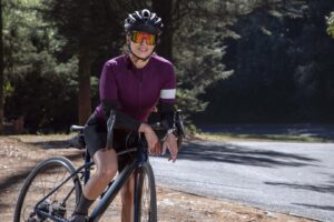 Frau auf Fahrrad mit Helm und Brille